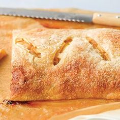 an apple turnover sitting on top of a cutting board