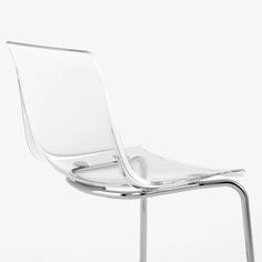 a white chair sitting on top of a metal frame