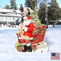 a santa clause sitting on top of a sleigh in the snow