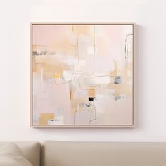 an abstract painting hangs on the wall above a couch in a living room with white walls