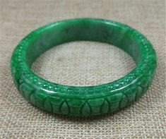 59mm Emerald Green Hand carved Moire Pattern Jadeite Jade #432 Bangle  Bracelet Love this jadeite bangle? Email us with questions. Size:  59mm x 12mm Weight: tbd This is a beautiful jadeite bangle! Subtle and rich.   Jadeite is a very gentle and strong healing stone that will help amplify the body's natural self-healing capacity. Elegant Green Carved Bangle, Elegant Carved Green Bangle, Green Carved Bangle Bracelet, Green Carved Bangle Bracelets, Carved Jade Bangle As A Gift, Green Carved Round Bangle, Carved Green Jade Bangle, Carved Jade Bangle Bracelet, Carved Jade Bracelets