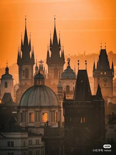 the sun is setting over an old city with many spires and domes on it