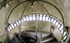 a spiral staircase in a building with lots of windows