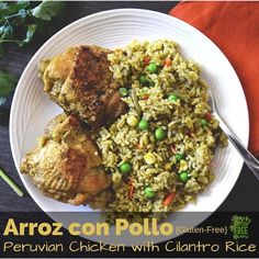 a white plate topped with chicken and rice next to a green leafy garnish