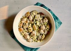 a white bowl filled with food on top of a blue napkin