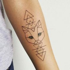 a woman's arm with a tattoo on it that has an image of a fox