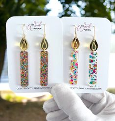 Birthday Candle long earrings make for a unique gift or a treat to yourself, embodying the spirit of celebration and joy. Whether it's a milestone birthday or a simple celebration, these earrings are a delightful way to commemorate special moments. Crafted from premium acrylic glitter, mirror acrylic, and stainless steel, these earrings offer a lightweight yet durable design. Their dimensions, measuring at 2.7" from hook and 0.5" wide, ensure a perfect balance of statement and subtlety. Experien Gold Earrings For Mother's Day Party, Party Earrings For Mother's Day, Trendy Adjustable Earrings For Birthday, Trendy Earrings For Mother's Day Gift, Handmade Jewelry For Party Gifts, Handmade Jewelry For Parties And Gifts, Trendy Earrings For Anniversary And Mother's Day, Handmade Jewelry For Party And Gift-giving Occasions, Nickel-free Multicolor Earrings For Birthday