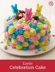 an easter cake decorated with colorful icing and bunnies