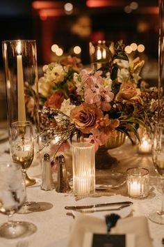 an elegant table setting with candles and flowers