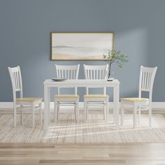 a dining room table with four chairs and a vase on the top of it, in front of a blue wall