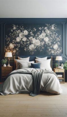 a large bed sitting in a bedroom next to a wall with flowers on it and two lamps