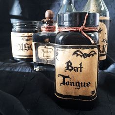 three bottles with bats on them are sitting next to each other in front of a black background