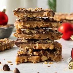 a stack of chocolate and nutty bars with christmas decorations in the backgroud