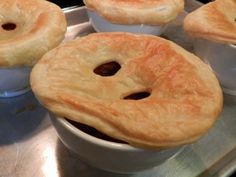 some pies are sitting in bowls on a tray