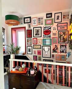 a living room filled with lots of pictures on the wall