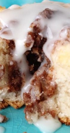 a close up of a doughnut with icing on a blue plate