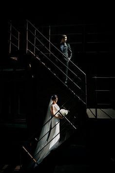 a bride and groom walking up the stairs