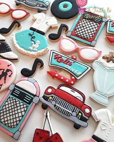 decorated cookies are arranged in the shape of cars and women's accessories on a table