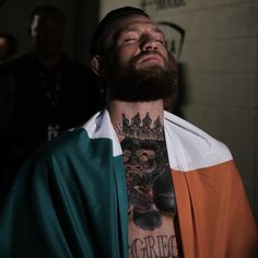 a man with tattoos on his neck and chest