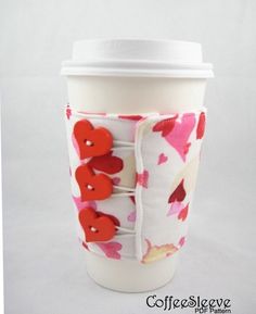 a coffee cup sleeve with red buttons on it and a white paper wrapper around the bottom