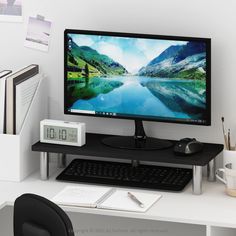 a computer monitor sitting on top of a desk