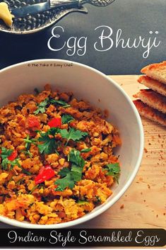 an egg bhuj is served in a white bowl with bread on the side