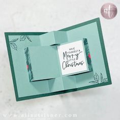 an origami christmas card with a note attached to the front and back of it