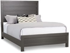 a bed with grey wood frame and pillows on it's headboard, in front of a white background