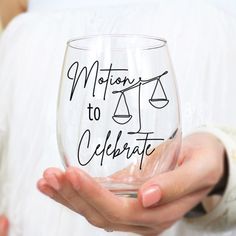 a person holding a wine glass with the words motions to celebrate written on it in black ink