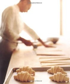 a man is preparing food on a counter top with chopsticks in front of him