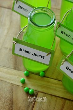 four green jars with name tags on them