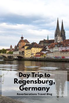 a river with buildings and the words day trip to regensburg, germany