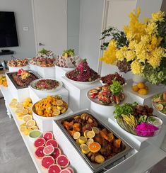 a buffet table filled with lots of different types of fruits and veggies on it