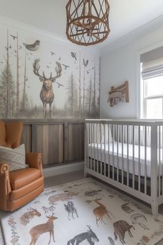 a baby's room with deer wallpaper and an orange chair in front of the crib