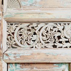 an old wooden door with carvings on it