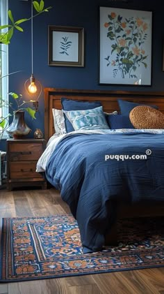 a bedroom with blue walls and wooden bed frame, artwork on the wall above it