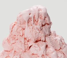 a pile of pink ice cream sitting on top of a table