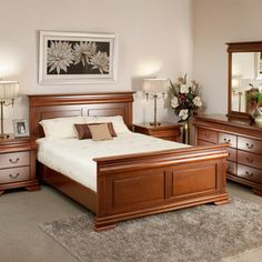 a bedroom scene with focus on the bed and dressers