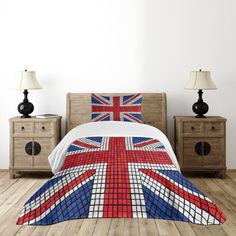 a bed covered in a british flag comforter next to two night stands and lamps