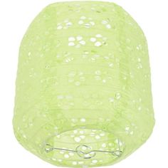 a green lamp hanging from the ceiling on a white wall with holes and circles in it