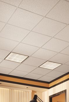 an empty room with two lamps on the ceiling