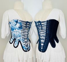 This corset is inspired by the classic shape with a few modern twists, designed to be worn with a V shape in the front it is reversible in nature with one side being a Blue Floral Bird Cotton and Ink Blue Velvet  Laced with a matching 4m cotton cord in a way that facilitates the swapping between the two sides with ease.  A fabulous addition to any wardrobe and made of 60% recycled fabrics This stays style corset is designed to be worn with a gap in the front Size M Bust 31" Waist 28" I recommend Blue Corset Dress With Fitted Bodice, Blue Corset With Boned Bodice, Blue Fitted Underbust Corset Dress, Blue Overbust Corset With Boned Bodice, Blue Underbust Corset With Fitted Bodice, Elegant Blue Corset With Corset Back, Blue Underbust Corset With Boned Bodice, Elegant Blue Underbust Corset, Blue Fitted Corset With Corset Back