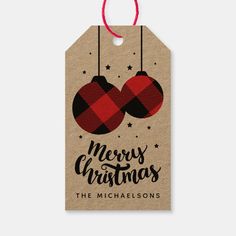 a christmas gift tag with two ornaments hanging from it