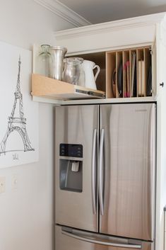 a stainless steel refrigerator freezer sitting inside of a kitchen next to a wooden shelf