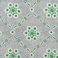 a green and white flower pattern on grey fabric