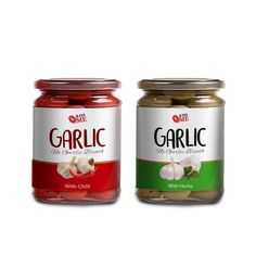 two jars of garlic with herbs on white background