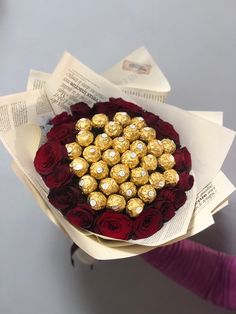 a bouquet of roses and chocolates in the shape of a heart