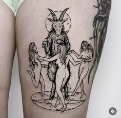 a woman's thigh with an image of a horned goat on it and three other women around her