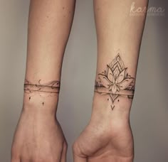 two people with matching tattoos on their arms and wrist, both holding each other's hands