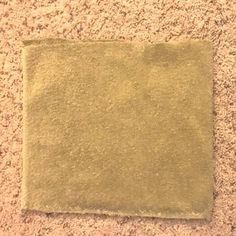 a piece of paper that is on the ground next to a carpeted area with some dirt